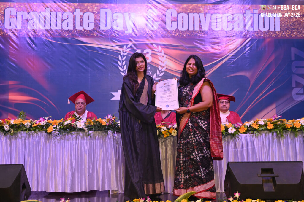 Graduation ceremony with certificate presentation, traditional attire, and floral decorations.