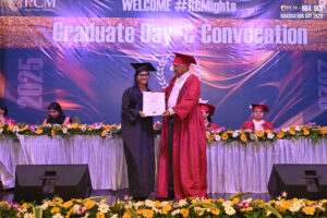 Graduate receiving certificate on stage during 2025 convocation at Regional College of Management.