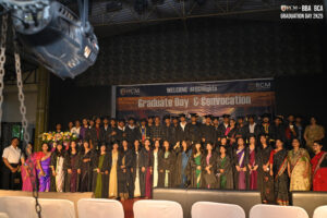Graduates in regalia on stage at RCM Graduate Day and Convocation 2025.
