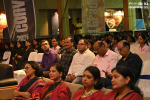 People seated at an indoor event with banners reading "Graduation Day 2K25" and "BBA BCA."
