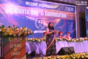 Woman in sari speaks on stage at RCM Global School's 2025 convocation, celebrating 43 years.