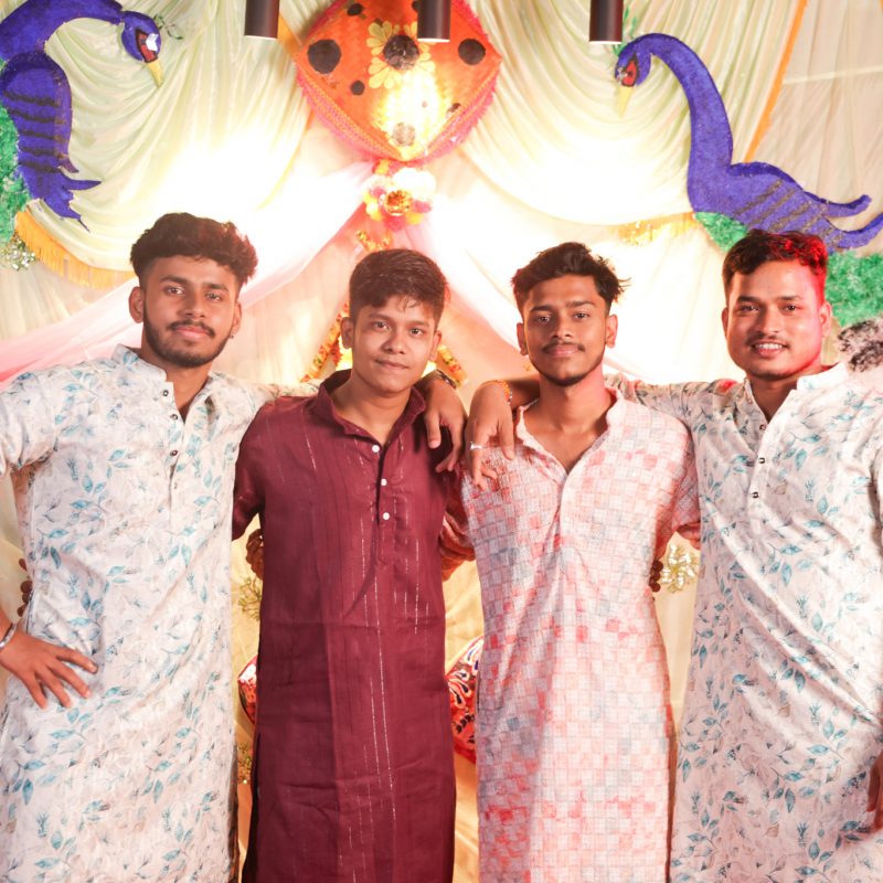 Group of male students in traditional attire posing at Mega Dandiya Night 2025 college cultural event.