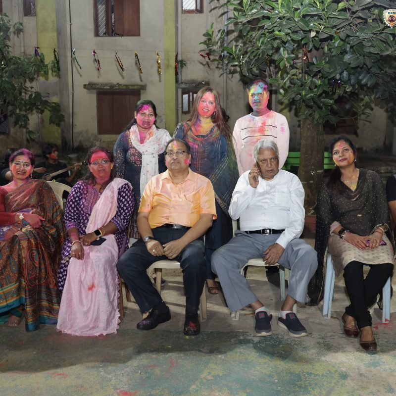 Professors and staff enjoying Holi festivities with students at RCM.