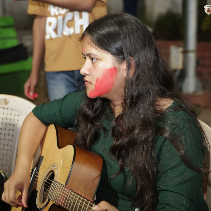 A student enjoying Holi while playing a soulful tune on the piano.