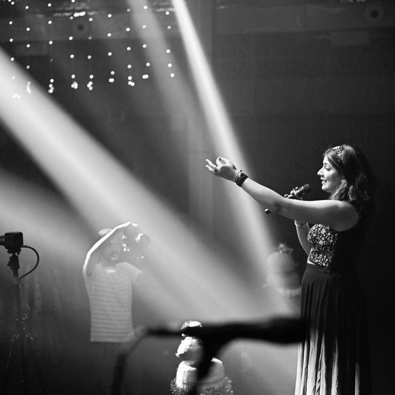 Singer Sugyani performing live at Mega Dandiya Night 2025 with students enjoying vibrant college fest celebration.